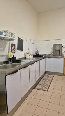 a kitchen with white cabinets and a counter top at Taman Sunway Tunas in Bayan Lepas
