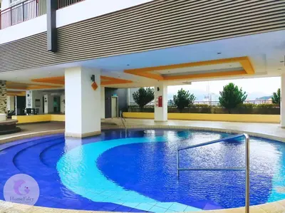a large blue swimming pool in a building at The Majestic Condo Ipoh Home Fairy 4 in Ipoh