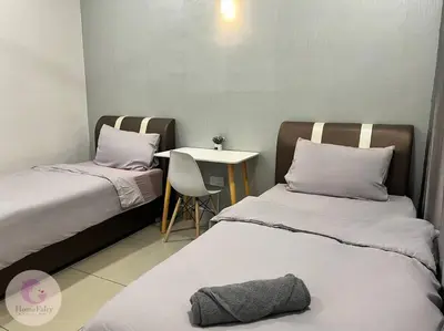 a room with two beds and a table with a chair at The Majestic Condo Ipoh Home Fairy 4 in Ipoh
