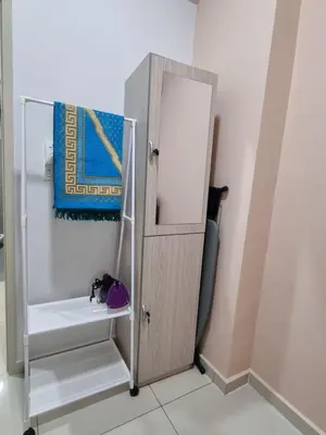 a bathroom with a wooden door and a mirror at NuTiQa Homestay Meru Ipoh Perak in Ipoh