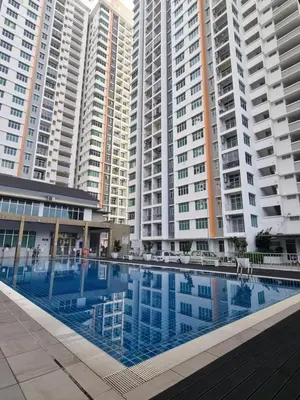 a large swimming pool in front of tall buildings at NuTiQa Homestay Meru Ipoh Perak in Ipoh