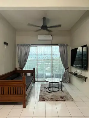 a living room with a ceiling fan and a table at Dsyahna homestay in Ipoh
