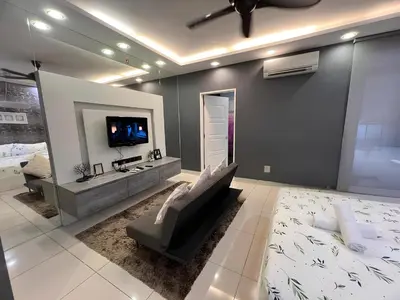 a living room with a couch and a flat screen tv at Mansion One l 5pax 1R1B l Cityview l Gleneagle l by PerfectSweetHome in George Town
