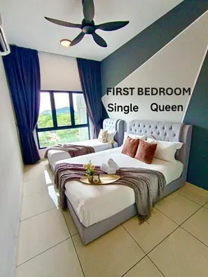 a bedroom with two beds and a ceiling fan at The Horizon Ipoh Belle Vue by Grab A Stay in Ipoh
