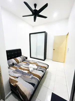 a bedroom with a bed and a ceiling fan at JaszSpace at Kulim Hi-Tech - All Room Aircond,Wifi,Netflix in Kulim