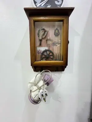a clock hanging on a wall with some items at JaszSpace at Kulim Hi-Tech - All Room Aircond,Wifi,Netflix in Kulim
