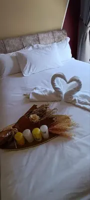 a tray with feathers and eggs on a bed at The Horizon Ipoh Dual L13A by Grab A Stay in Ipoh