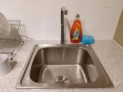 a kitchen sink with a bottle of detergent next to it at The Horizon Ipoh Dual L13A by Grab A Stay in Ipoh