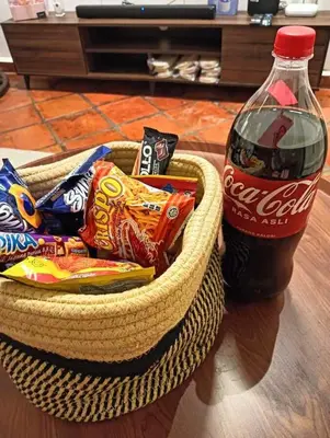 a basket of chips and a bottle of soda at New! 9 pax Georgetown Heritage Pre-war House 3BR in George Town