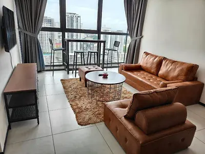 a living room with a couch and a table at Urban Suites Georgetown Penang - Sea View & Georgetown View - High Floor - Exclusive & Cozy Stay in George Town