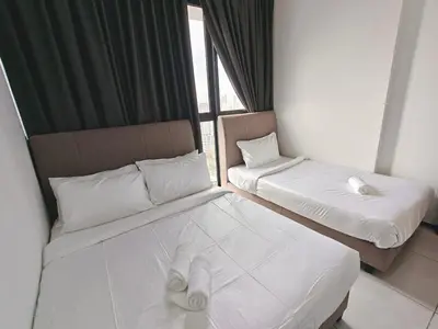 two beds in a room with a window at Urban Suites Georgetown Penang - Sea View & Georgetown View - High Floor - Exclusive & Cozy Stay in George Town