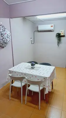 a table with two chairs and a white table with a white table cloth at Faza Homestay Meru Ipoh in Ipoh