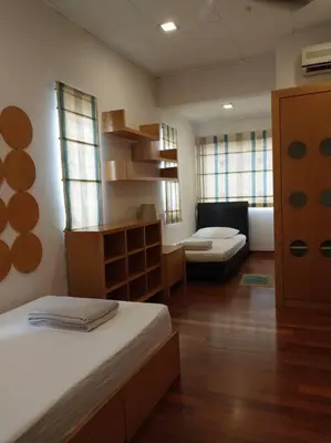 a room with a bed and a living room with a couch at Bayan Baru in Bayan Lepas