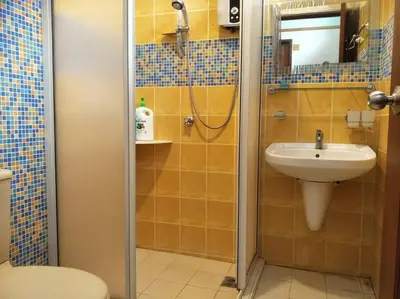 a bathroom with a shower with a sink and a toilet at Bayan Baru in Bayan Lepas