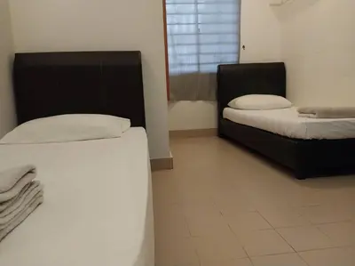 two beds in a room with two bedsskirts at Bayan Baru in Bayan Lepas