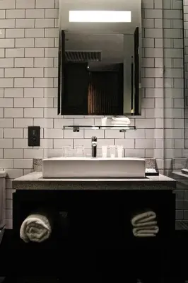 a bathroom with a white sink and a mirror at WEIL Hotel Ipoh in Ipoh
