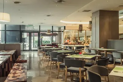 a restaurant with tables and chairs in a building at WEIL Hotel Ipoh in Ipoh