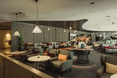 a restaurant with tables and chairs and a lobby at WEIL Hotel Ipoh in Ipoh