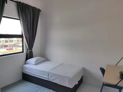 a small bedroom with a bed and a window at Nixy Studio Seri Iskandar in Seri Iskandar