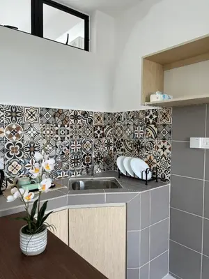 a kitchen with a sink and a tile wall at Nixy Studio Seri Iskandar in Seri Iskandar