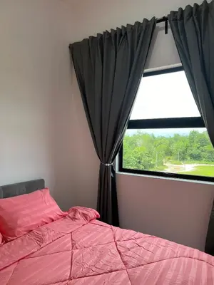 a bedroom with a pink bed and a window at Nixy Studio Seri Iskandar in Seri Iskandar