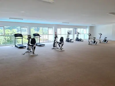 a gym with rows of exercise equipment in a room at Premier Family Suite & City View Seven Houz Ipoh in Ipoh
