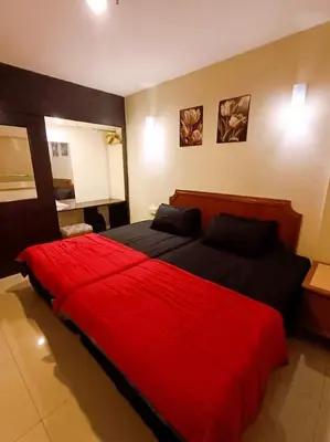 a bedroom with a large red bed in a room at D'Marina 1 HOMESTAY LUMUT MANJUNG in Lumut