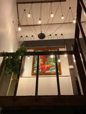 a painting of flowers on a wall with lights at Homs Female Hostel in George Town