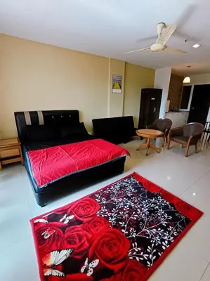 a bedroom with a bed with roses on the floor at Marina HOMESTAY JETI LUMUT MANJUNG in Lumut