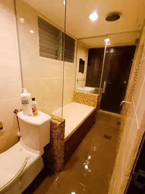 a bathroom with a toilet and a tub and a shower at Marina HOMESTAY JETI LUMUT MANJUNG in Lumut