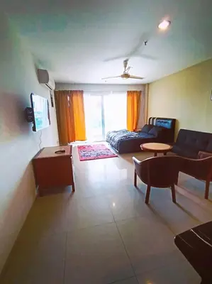 a living room with a couch and a table at Marina HOMESTAY JETI LUMUT MANJUNG in Lumut