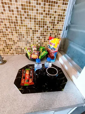 a table with snacks and water bottles on the floor at Marina HOMESTAY JETI LUMUT MANJUNG in Lumut