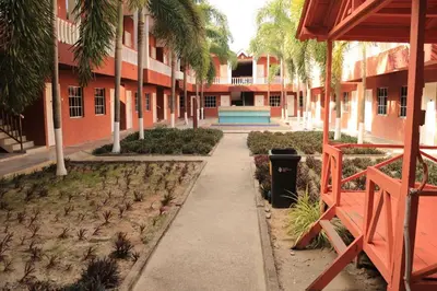 a sidewalk in front of a building with a trash can at Hornbillbay Beach Resort in Kampung Teluk Nipah