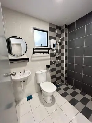 a bathroom with a toilet and a sink and a mirror at Booyen hills in Tanah Rata