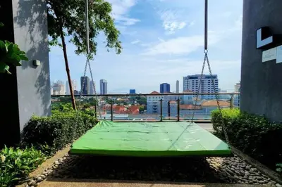 a green tennis court with a view of a city at Seaview Studio Tropicana 218 Macalister Georgetown in George Town