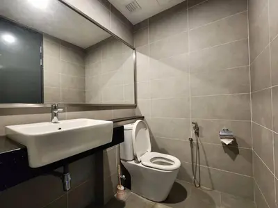 a bathroom with a white toilet and a sink at Seaview Studio Tropicana 218 Macalister Georgetown in George Town