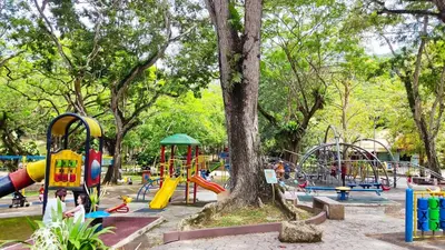 a park with a playground with a tree and slides at Scotland 18 Lodge in George Town