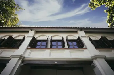 a white building with black windows on it at Muntri Grove in George Town