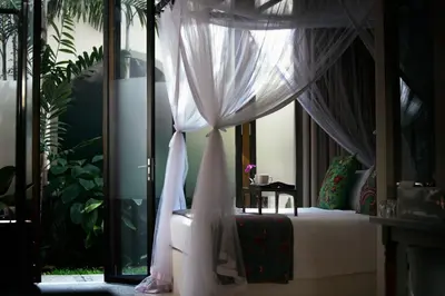 a bedroom with a bed with a canopy at Muntri Grove in George Town