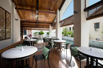 a row of tables and chairs in a restaurant at Muntri Grove in George Town