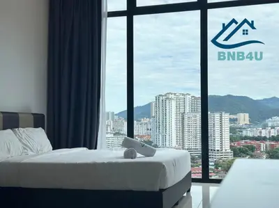 a bedroom with a bed and a large window at Beacon 2BR Infinity Pool - By BNB4U in George Town