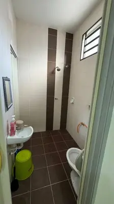 a bathroom with a toilet and a sink at Homestay Bagan Serai in Bagan Serai