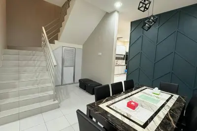 a room with a table and chairs and a staircase at Homestay Bagan Serai in Bagan Serai