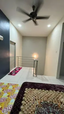 a room with a ceiling fan and a rug at Homestay Bagan Serai in Bagan Serai