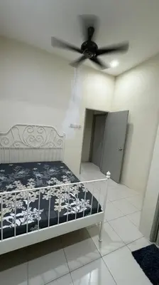 a bedroom with a bed with a ceiling fan at Homestay Bagan Serai in Bagan Serai