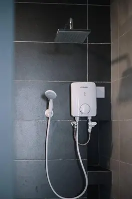 a shower in a bathroom with a hair dryer at Seaview Infinity Pool 3BR 2Carparks 8Pax 401 in Jelutong
