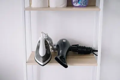 a hair dryer and a phone on a shelf at Seaview Infinity Pool 3BR 2Carparks 8Pax 401 in Jelutong