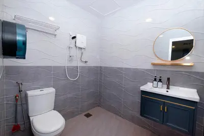 a bathroom with a toilet and a sink and a mirror at Hotel Lavie at Centrum in Brinchang