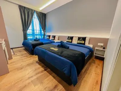 a bedroom with two beds with blue sheets and a window at Hotel Lavie at Centrum in Brinchang