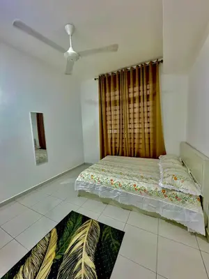 a bedroom with a bed in the middle of a room at Aura Homestay in Sungai Petani